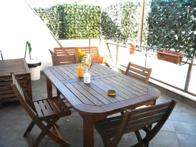 a wooden table and chairs on a patio at Terrazzo Trieste-Africano in Rome