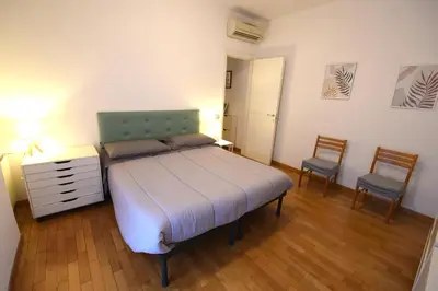 a bedroom with a bed with a dresser and two chairs at Terrazzo Trieste-Africano in Rome