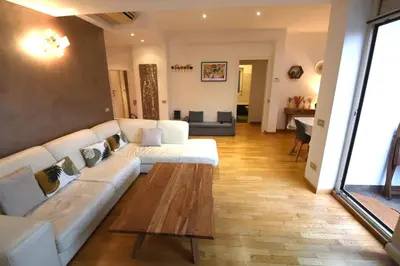 a living room with a white couch and a coffee table at Terrazzo Trieste-Africano in Rome
