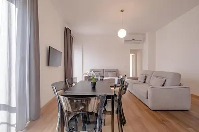 a living room with a table and a couch at Oriana Homèl Roma in Rome