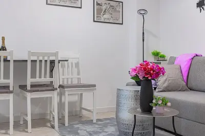 a living room with a couch and a table with flowers at cosy apt close to metro San Paolo in Rome