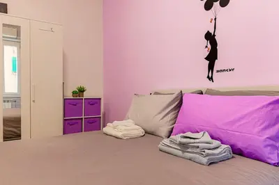 a bedroom with a bed with a mermaid on the wall at cosy apt close to metro San Paolo in Rome
