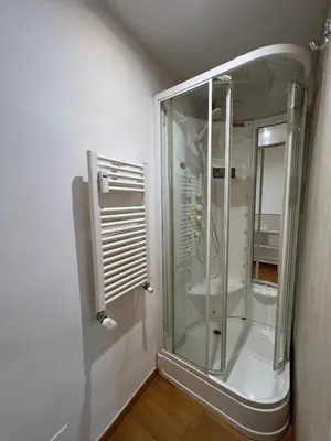 a bathroom with a glass shower in a room at Tiburtina68 central apartment in Rome