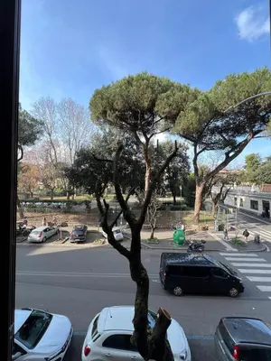 a view of a parking lot with cars parked at Tiburtina68 central apartment in Rome