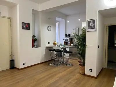 a living room with a kitchen and a table in it at Tiburtina68 central apartment in Rome