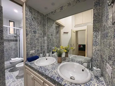 a bathroom with a sink and a toilet and a mirror at Tiburtina68 central apartment in Rome