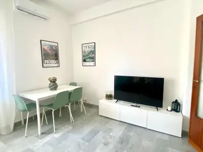 a living room with a television and a table and chairs at La Casa di Giada in Rome