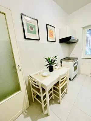 a kitchen with a white table and a plant on it at La Casa di Giada in Rome