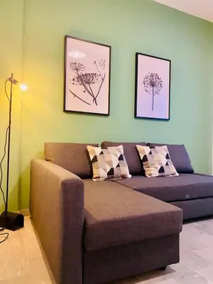 a living room with a couch and two pictures on the wall at La Casa di Giada in Rome