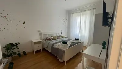 a bedroom with a bed in a white room at Apartment in the heart of Rome in Rome