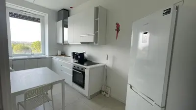 a white kitchen with a stove and a refrigerator at Apartment in the heart of Rome in Rome
