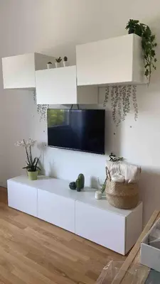 a white living room with a tv on the wall at Apartment in the heart of Rome in Rome