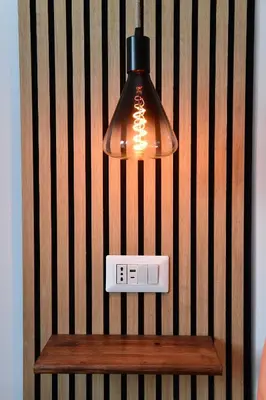 a light hanging over a table with a clock on it at Nest house in Rome