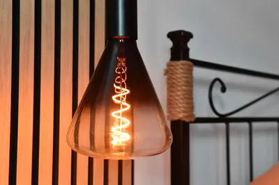a glass light hanging from a black pole at Nest house in Rome