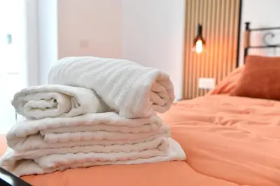 a pile of towels sitting on top of a bed at Nest house in Rome