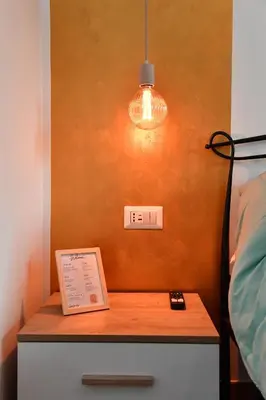 a table with a book on it next to a bed at Nest house in Rome