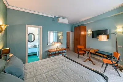 a bedroom with a bed and a table and a desk at Tu chiamale emozioni intero appartamento in Rome
