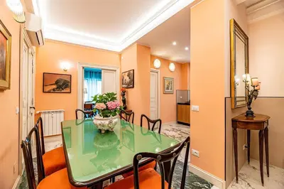 a dining room with a glass table and chairs at Tu chiamale emozioni intero appartamento in Rome