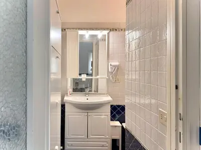 a small bathroom with a sink and a mirror at La Casa Blu in Rome