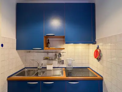 a kitchen with blue cabinets and a sink at La Casa Blu in Rome