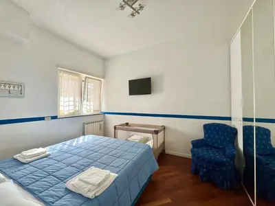 a bedroom with a blue bed and a blue chair at La Casa Blu in Rome