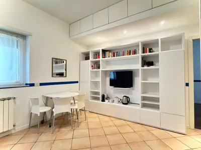 a dining room with a table and a tv at La Casa Blu in Rome