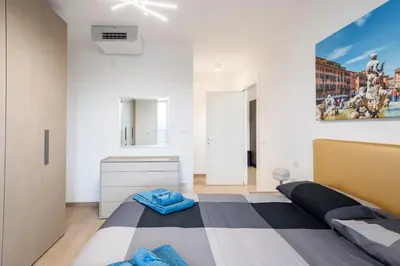 a bedroom with a bed and a painting on the wall at Private Parking - Bilocale Monti Tiburtini in Rome