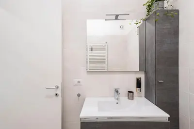 a bathroom with a sink and a mirror at Private Parking - Bilocale Monti Tiburtini in Rome