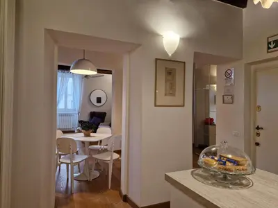 a kitchen and living room with a table and chairs at Piazza Cancelleria in Rome