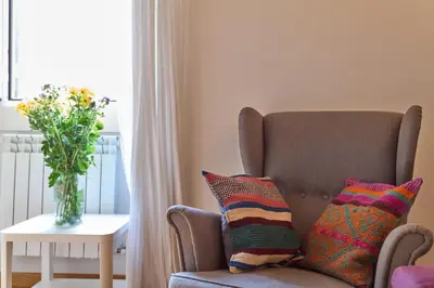 a living room with a couch and a vase of flowers at Piazza Cancelleria in Rome