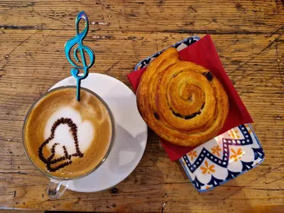 a cup of coffee and a pastry on a table at Piazza Cancelleria in Rome