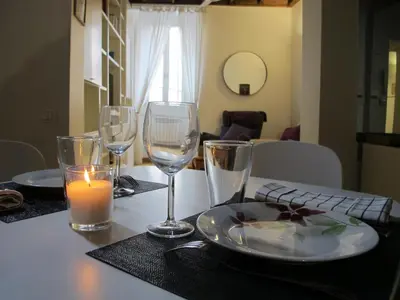 a table with a plate of food and wine glasses at Piazza Cancelleria in Rome