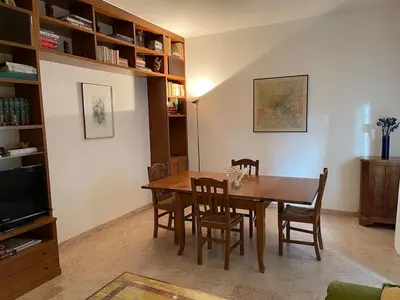 a dining room with a wooden table and chairs at Desy Vatican House in Rome