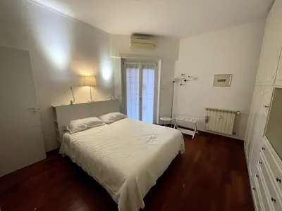 a bedroom with a white bed and a window at Desy Vatican House in Rome