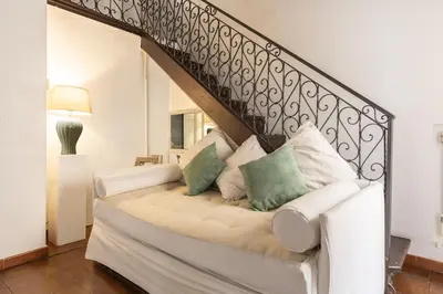 a white couch with pillows on it in a living room at Piazza Navona Loft for 7 people in Rome