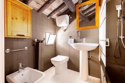 a small bathroom with a sink and a toilet at Piazza Navona Loft for 7 people in Rome