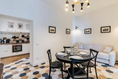 a living room with a table and chairs and a couch at Rome at Home in Rome