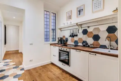 a kitchen with a sink and a stove top oven at Rome at Home in Rome