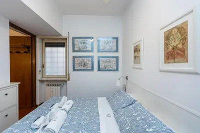 a bedroom with a bed in a white room at Trastevere Relax by Rental in Rome in Rome