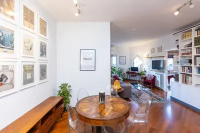 a living room with a table and chairs at Trastevere Relax by Rental in Rome in Rome