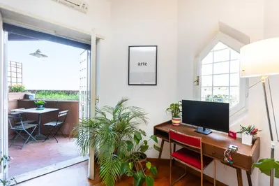 a home office with a desk with a computer on it at Trastevere Relax by Rental in Rome in Rome