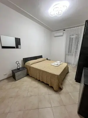 a bedroom with a bed and a television in it at Apartment Dacia Colosseum in Rome