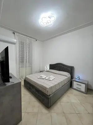 a bedroom with a bed and a flat screen tv at Apartment Dacia Colosseum in Rome