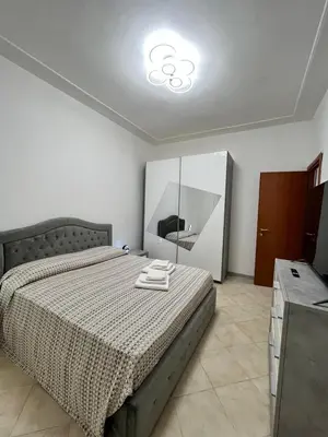 a bedroom with a large bed and a mirror at Apartment Dacia Colosseum in Rome