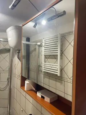 a mirror on a wall in a bathroom at Apartment Dacia Colosseum in Rome
