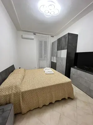 a bedroom with a bed and a television in it at Apartment Dacia Colosseum in Rome