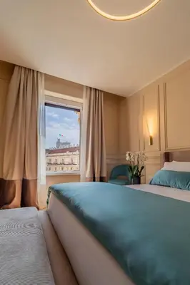 a bedroom with two beds and a window at Trevi Imperial Suite 3 in Rome