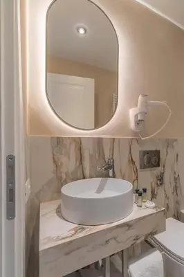 a bathroom with a white sink and a mirror at Trevi Imperial Suite 3 in Rome