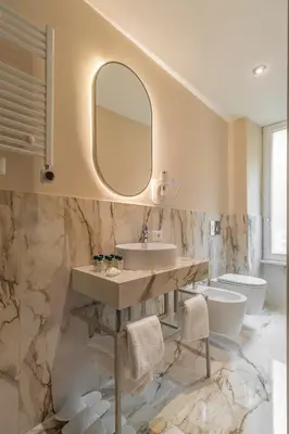 a bathroom with a sink and a toilet and a mirror at Trevi Imperial Suite 3 in Rome