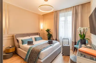 a bedroom with a bed and a tv in it at Trevi Imperial Suite 3 in Rome